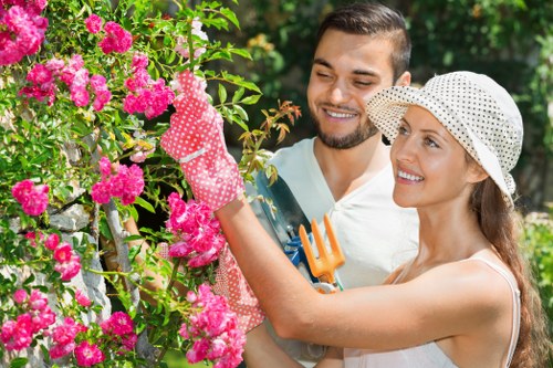 Gardener working safely with protective equipment in Chislehurst